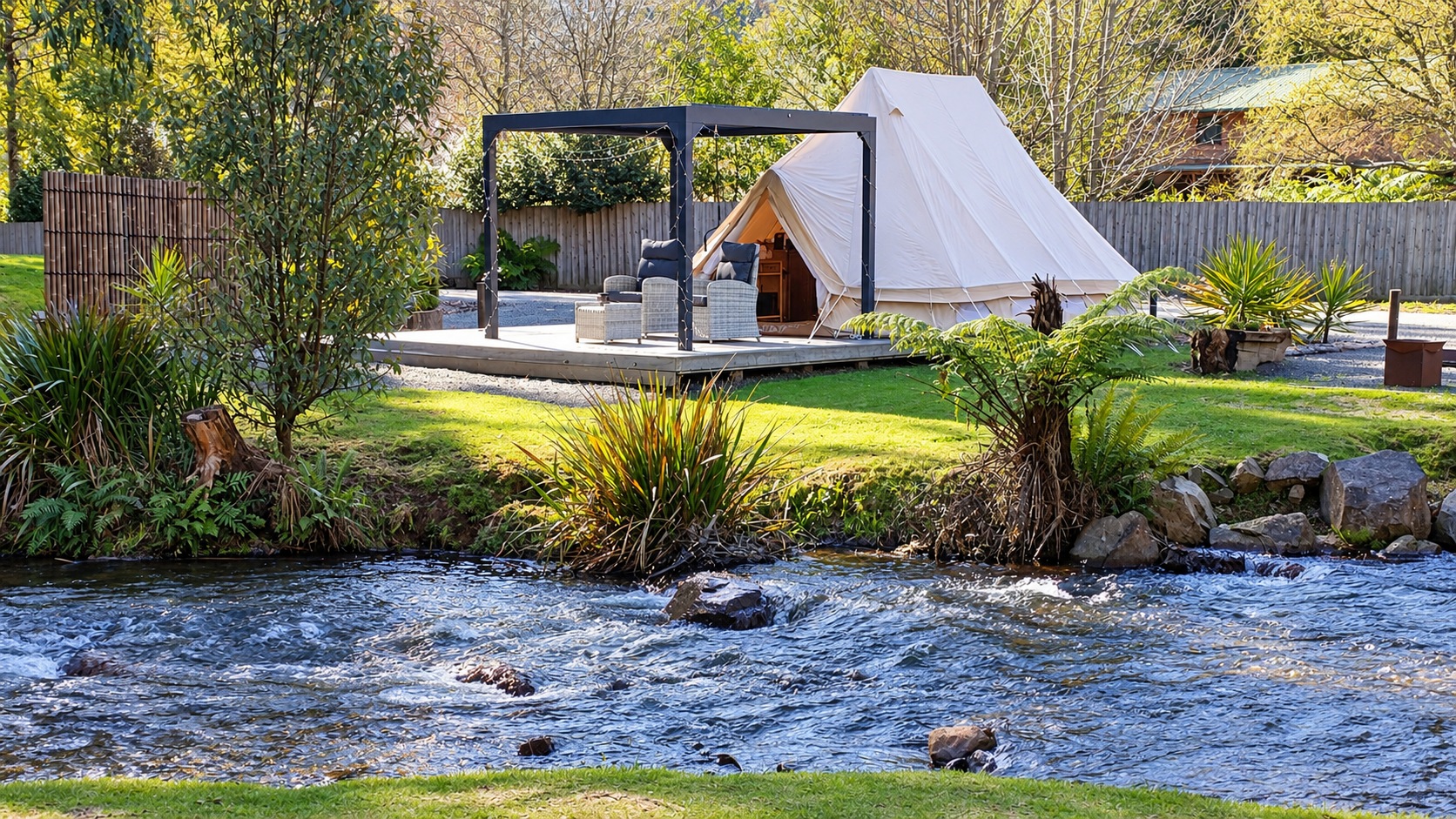 Canvas glamping tent and furnished deck beside the Steavenson River.